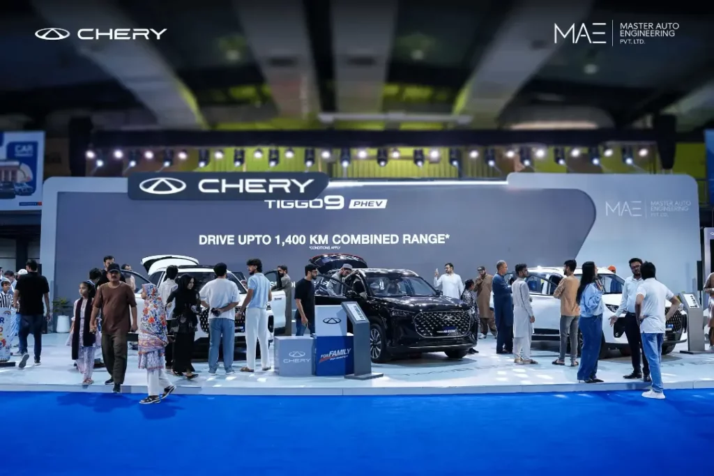 Crowd exploring the Chery Tiggo 9 PHEV display stand at the auto expo